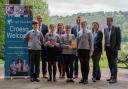 Headteacher Mark Hatch, independent Usborne partner Laura Rowlands,PC Dewi Owens, Phillipa Proctor, (CGI), Dave Evans, (PACT project manager) and Year 7 pupils at Ysgol Dinas Bran. Photo: Ethan Gilbert Media
