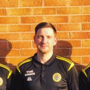 St Asaph City manager Daniel Brewerton (centre)