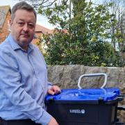 Denbighshire leader Cllr Jason McLellan with one of the council's new recycling  ‘Trolibocs on wheels’ - to replace their blue bin..