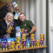 Lock Stock Self Storage Regional Sites Manager Lee Hanson hands over a delivery of Easter eggs to Pam Lake and Rob Sharpe of North Wales community group The Hummingbird Project.