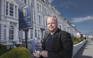 Manager Liam Donnelly at The Llandudno Bay Hotel with the Lux Life Sustainable Luxury Hotel Group of the Year Award