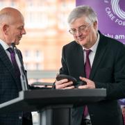 Mario Kreft, the chair of Care Forum Wales, presenting former First Minister Mark Drakeford with a Wales Care Award