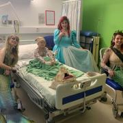 The mermaids visit a young patient on the children's ward