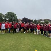Members of the opposing teams during the tea interval with Grove Park players in red.