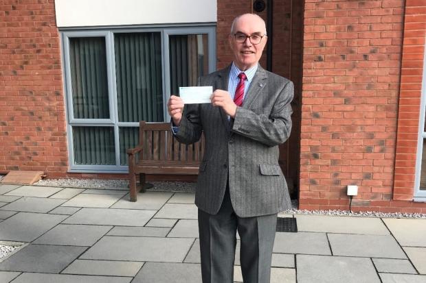 Syd Gaskin and the cheque for Rhuddlan Dementia Group