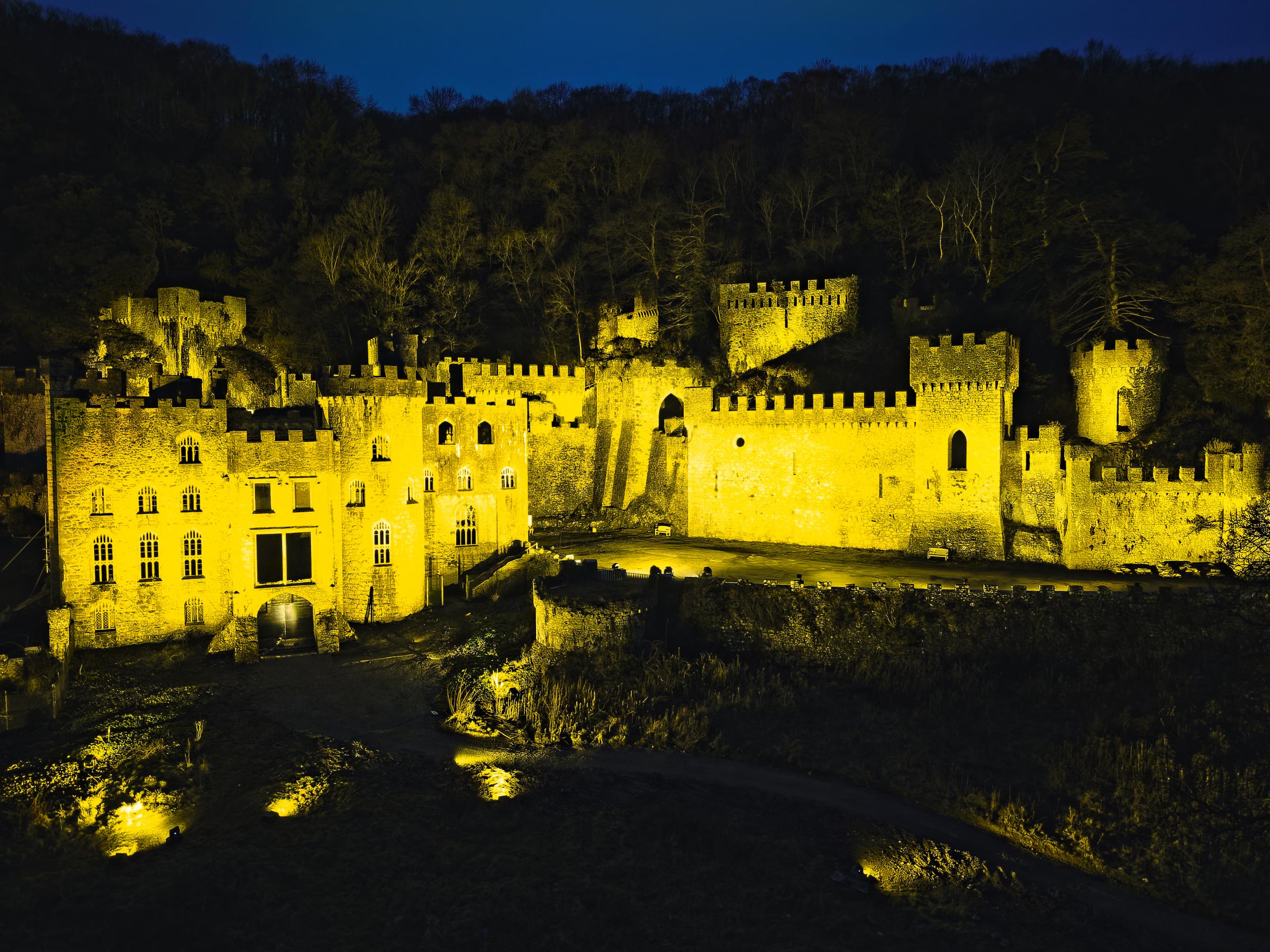 Gwrych Castle near Abergele is lit in yellow. Picture: Illuminated Events of Menai Bridge