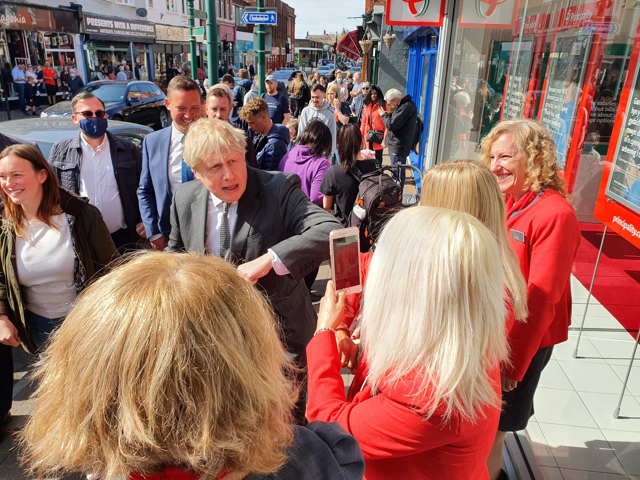 Boris Johnson elbow bumps Principality staff on the High Street. Picture: James Davies MP/Twitter