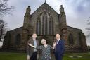 Mair Dowell (centre) who has appeared in a Good Friday concert every year since 1965 Pictured  at St Asaph Cathedral with Conductor Trystan Lewis and Pendine Park Proprietor Mario Kreft MBE.