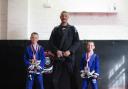Joseph and Jim Bolton receive their grading from Michael Maarup Pedersen in Rhyl