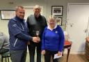 Richard Chappell (left) and Lesley Williams (right) being presented with the jubilee trophy by club captain Peter Storey (centre)