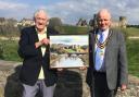 Gwynfor Griffiths presents his piece to Mayor Mike Elgin, with Rhuddlan Castle in the background.
