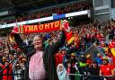 Dafydd Iwan sang his folk favourite Yma O Hyd before Wales' game against Ukraine that sealed World Cup qualification but despite its popularity with fans it hasn't appeared on the official chart. Picture: Gruffydd Thomas/Huw Evans Agency