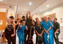 Mike and Jules Peters with staff at North Wales Cancer Treatment Centre at Ysbyty Glan Clwyd Hospital. Image: The Alarm/Facebook