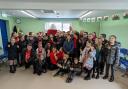 Cllr Mike Elgin, mayor of Rhuddlan, joins pupils in celebrating the opening of Hwb Rhuddlan on St David's Day