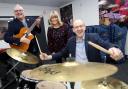 Banging the drum for award winning music service....Llyr Gruffydd MS at North Wales Music Co-operative with Head of Service Heather Powell and Chair, Cllr Mark Young