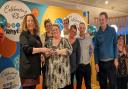 Volunteers from Rhyl's Mind charity shop collect their prize at the awards ceremony