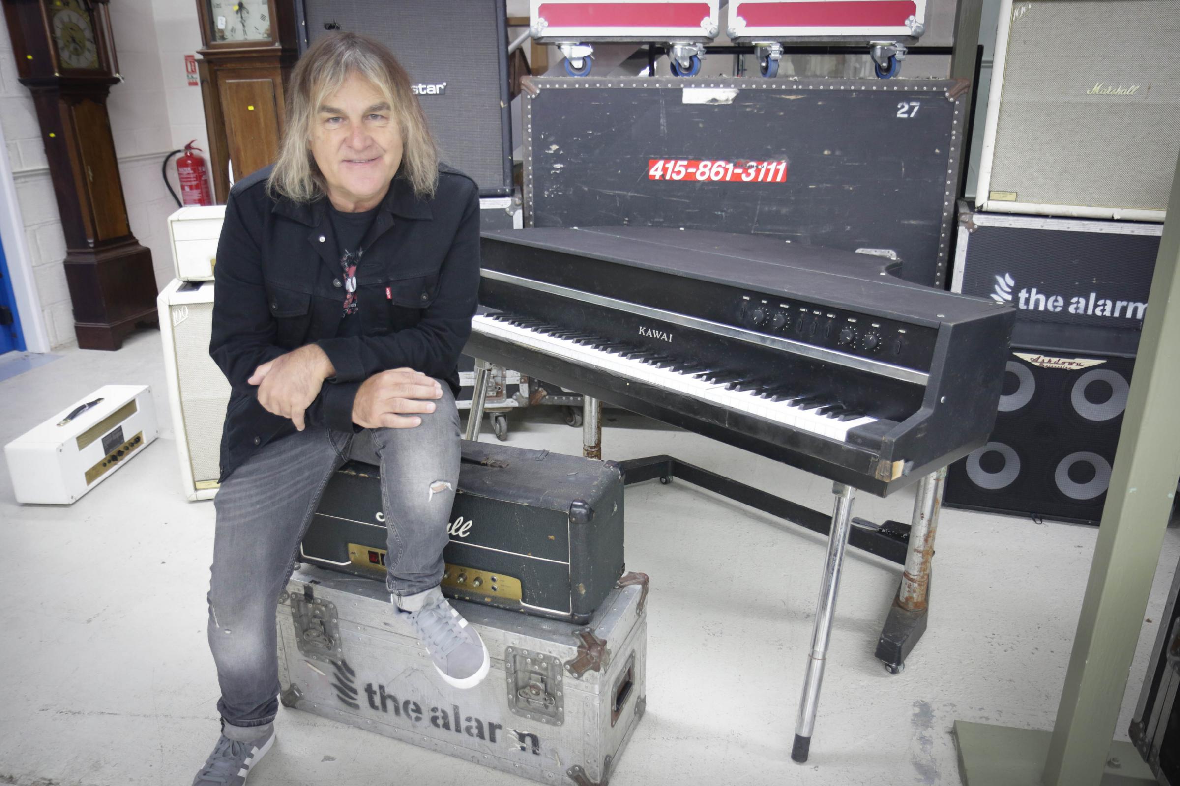 Undated handout photo issued by Gardiner Houlgate auctioneers of Mike Peters of The Alarm with a Kawai EP 308 baby grand electric piano, the band bought from British rock band Queen, and which is to be sold at auction next month. The auction will take