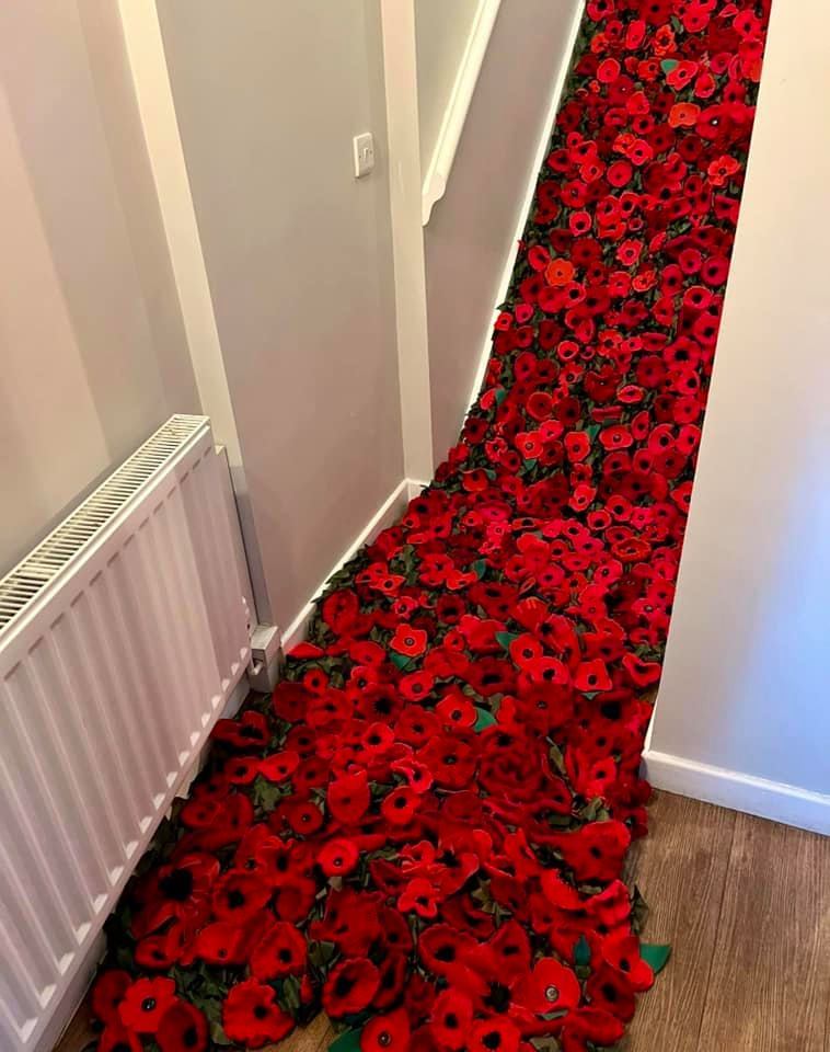 Volunteers have created this impressive handcrafted poppy cascade which will eventually be available to view at Gwrych Castle in 2022. Picture: Gwrych Castle / Facebook