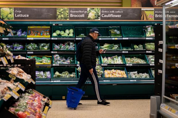 Rhyl Journal: A shopper walks through the salad aisle in a branch of Tesco (PA)