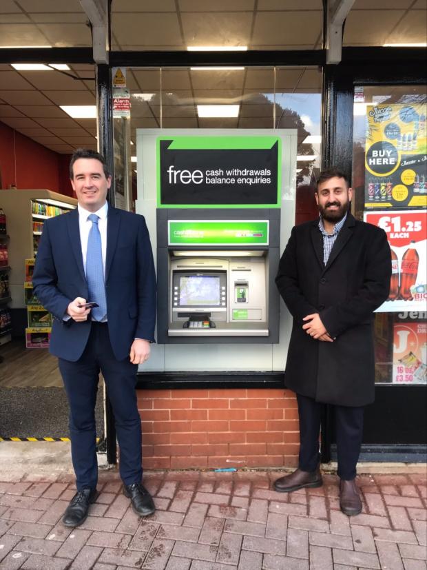 Rhyl Journal: Vale of Clwyd MP Dr James Davies and Arry Gill of Cardtronics at the new cash machine at Jenny's in Prestatyn High Street.