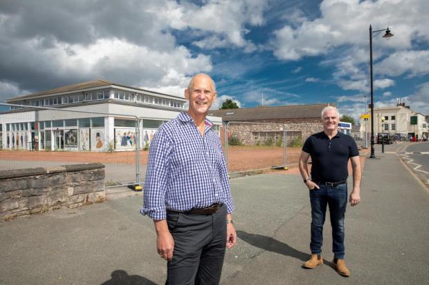 Rhyl Journal: Andrew Bowden, managing director of Cartrefi Conwy (left) and Cllr Charlie McCoubrey, leader of Conwy County Borough Council, in front of the Abergele site set for redevelopment. Picture: Mandy Jones