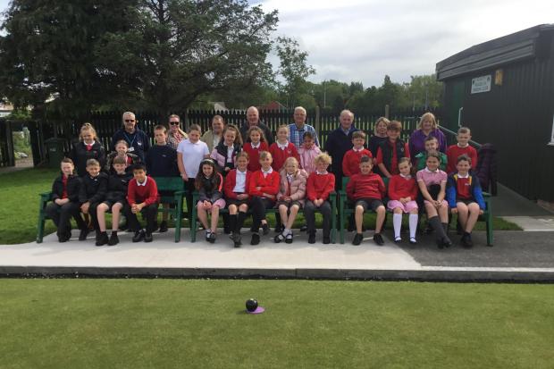 Ysgol Y Castell's Year Five pupils pictured with Colette Hughes, class teacher, and bowling club members. Photo: Colette Hughes