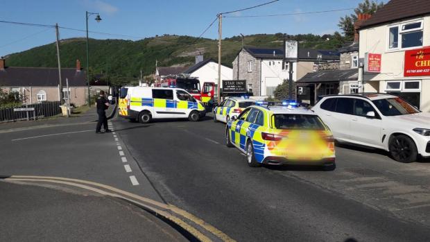 Rhyl Journal: The police presence following the incident in Meliden. Photo: Gerry Frobisher