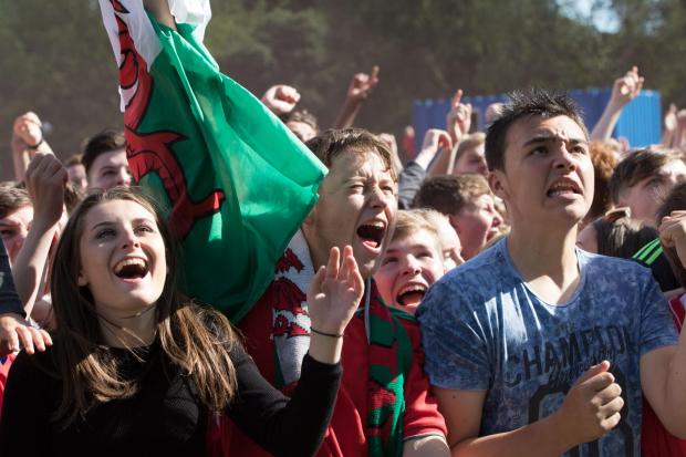 Rhyl Journal: Supporters watching Wales play Northern Ireland during Euro 2016 at the fanzone in Cardiff (Image: Huw Evans Picture Agency).