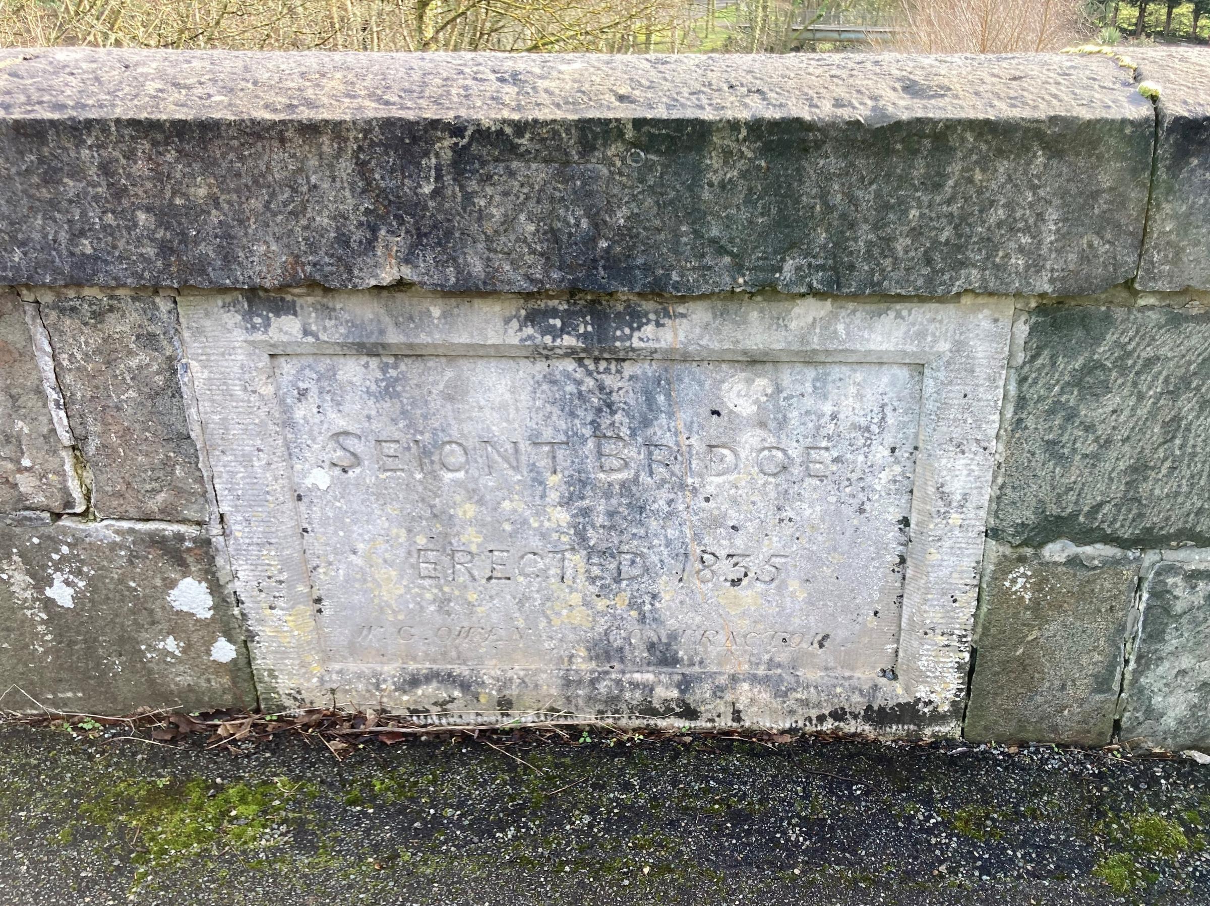The disused Seiont Bridge built in 1835 - the stone plaque remembers WG Owen