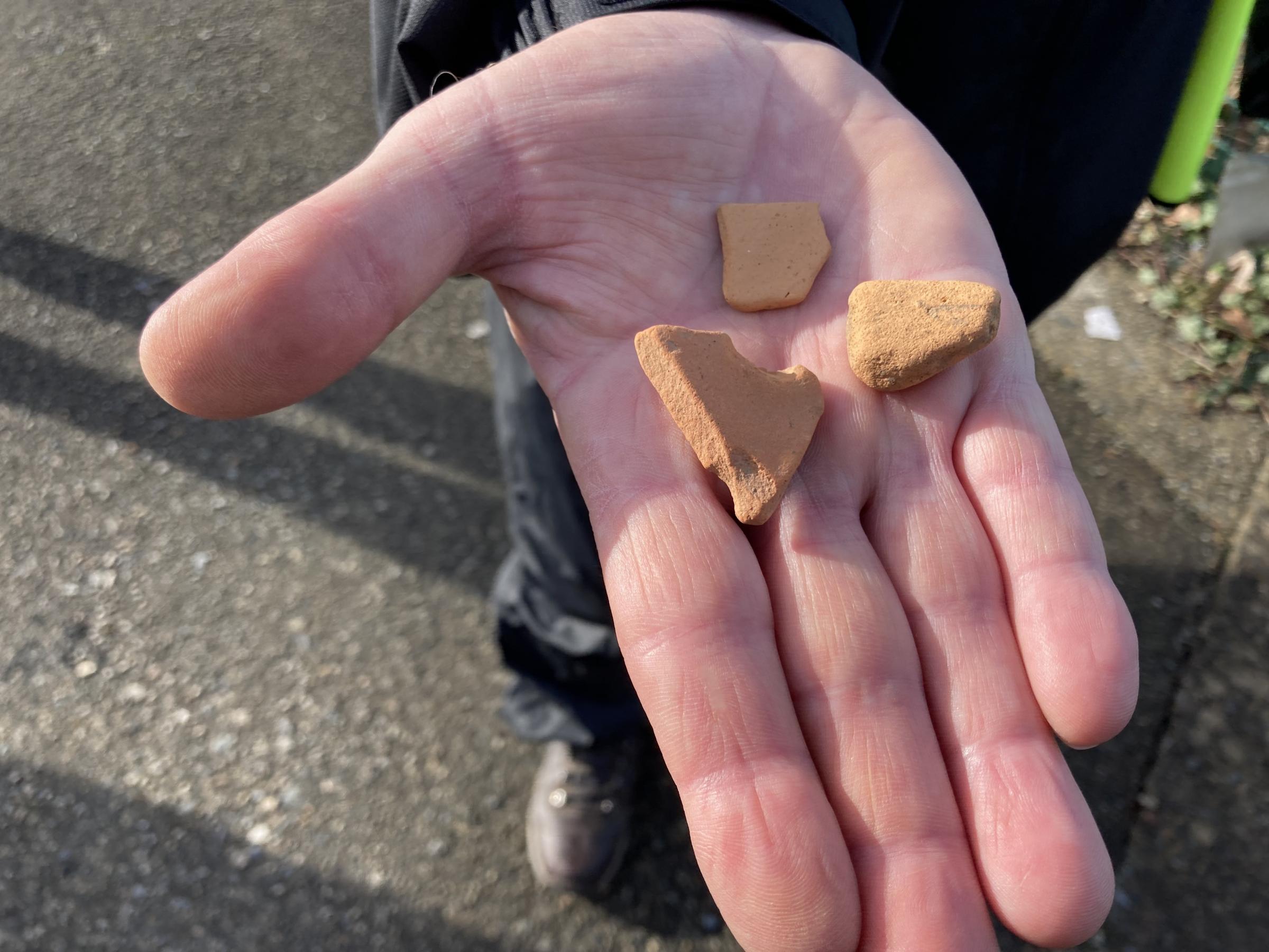 Rhys shows the puzzling shards of Roman pottery found In a field In Caernarfon 