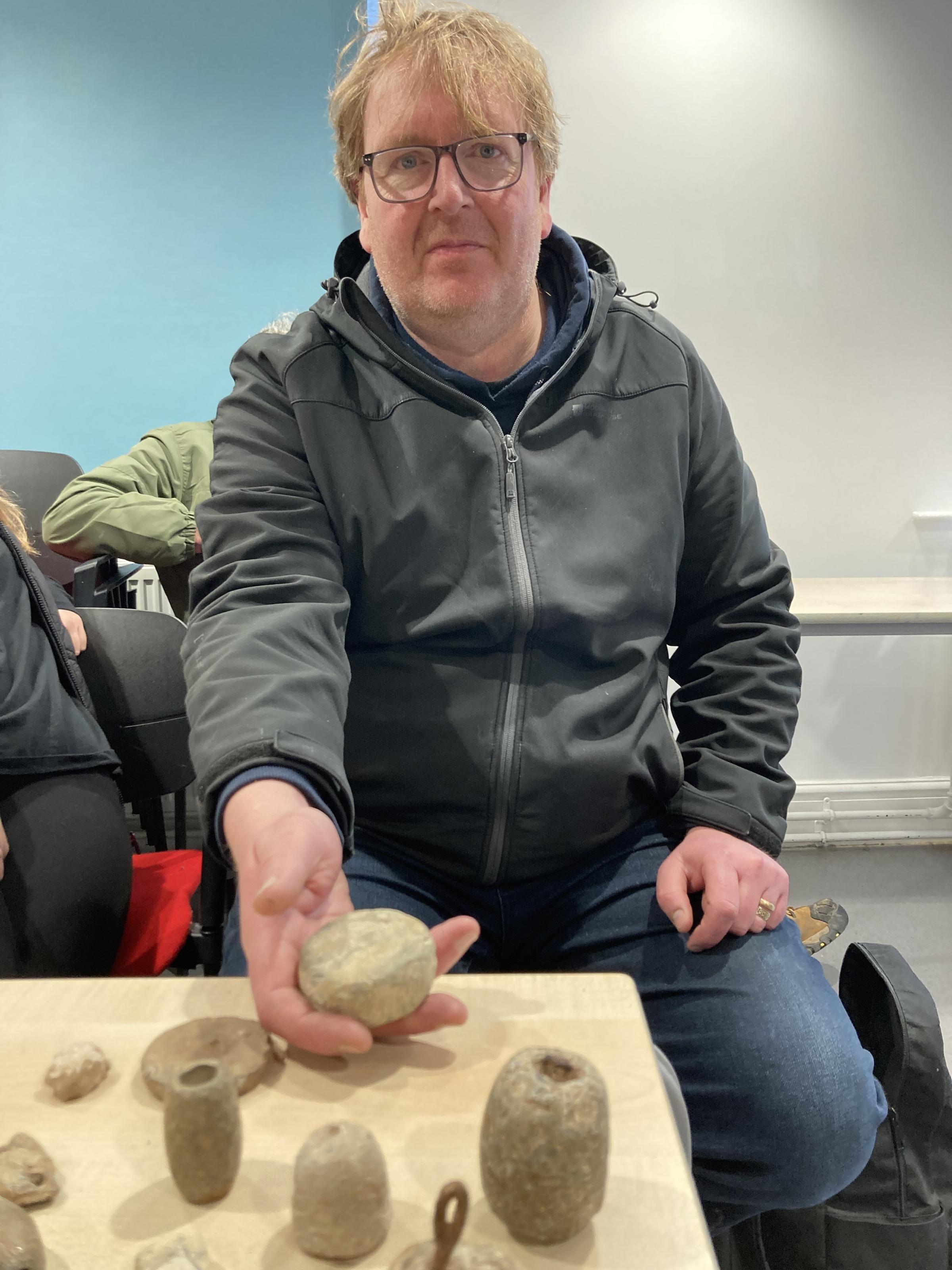 Steffan Coupe shows the lead Roman weights he has found on Anglesey whilst metal detecting (Image Dale Spridgeon)