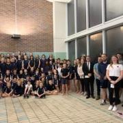 Memmber of the Rhyl Dolphins Swimming Club with representatives from the three charities
