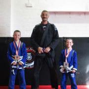Joseph and Jim Bolton receive their grading from Michael Maarup Pedersen in Rhyl