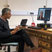 Dr Dilesh Thaker, Consultant Anaesthetist, and James Needham, Physiotherapist specialising in Pain Management, with the Attend Anywhere consultation software