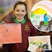 Elan Jones with her winning Christmas card design and prize