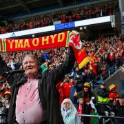 Dafydd Iwan sang his folk favourite Yma O Hyd before Wales' game against Ukraine that sealed World Cup qualification but despite its popularity with fans it hasn't appeared on the official chart. Picture: Gruffydd Thomas/Huw Evans Agency