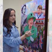 Elysia Gilman painting her picture celebrating Queen Elizabeth II. Photo: SWNS