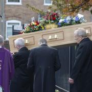 The coffin being carried from St Theresa's Catholic Church