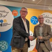 Alex Bowen of Use Your Loaf (right) collects one of his awards at the Rhyl BID Business Awards 2024