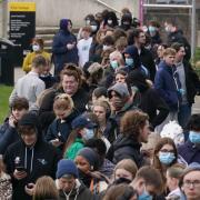 Students queuing for antibiotics outside a building at the University of Kent in Canterbury